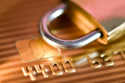 Close-up of a secure credit card with a lock, emphasizing online payment safety and security.