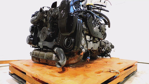 Subaru Legacy GT 2006-2012 EJ20X 2.0L Turbo engine on wooden pallet, showcasing its JDM manual transmission and components.